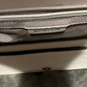 White Michael Kors purse. Have been worn a couple of times.